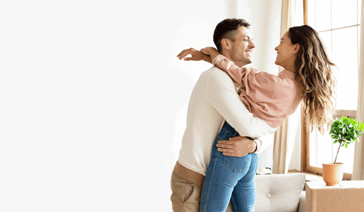 couple smiling and embracing in new home